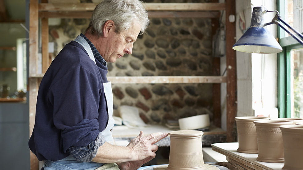 Crafting for mental health; man doing pottery